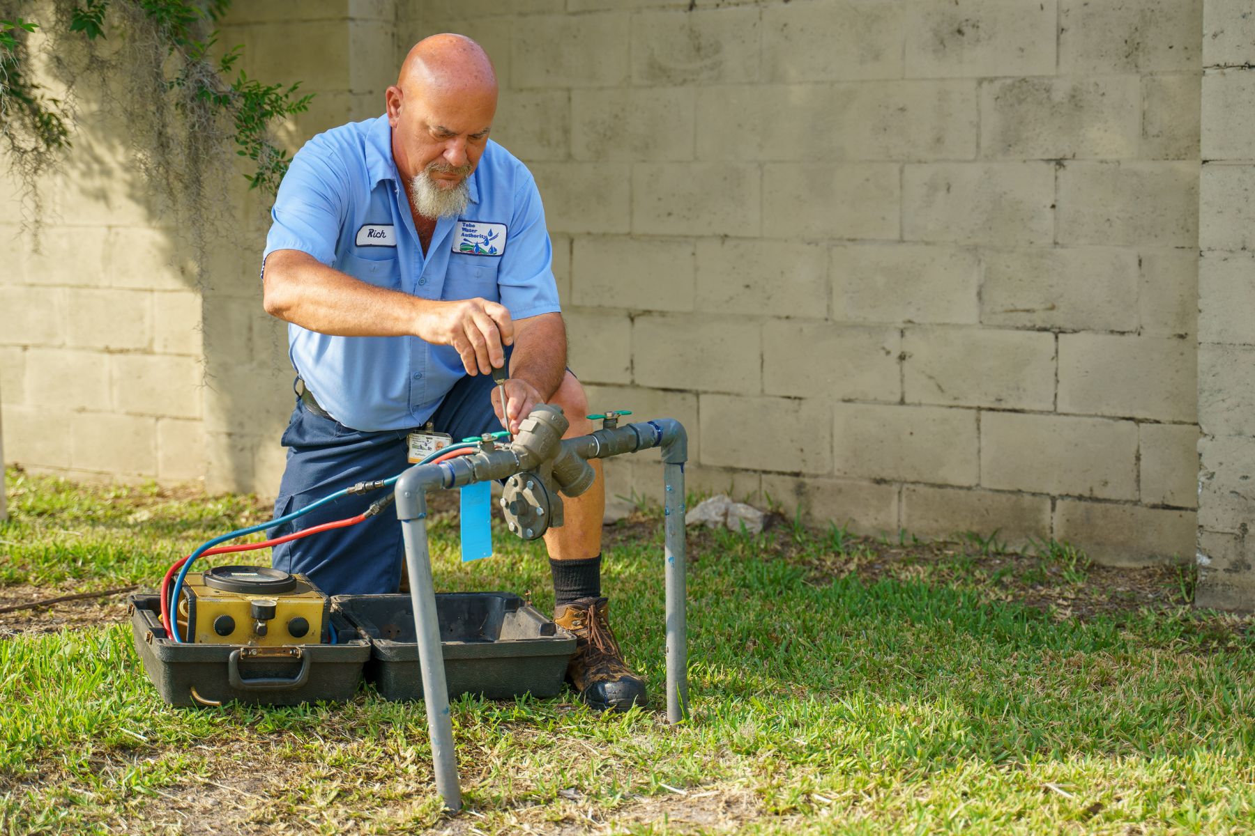 Shown in photo is a Toho team member servicing a backflow prevention device.