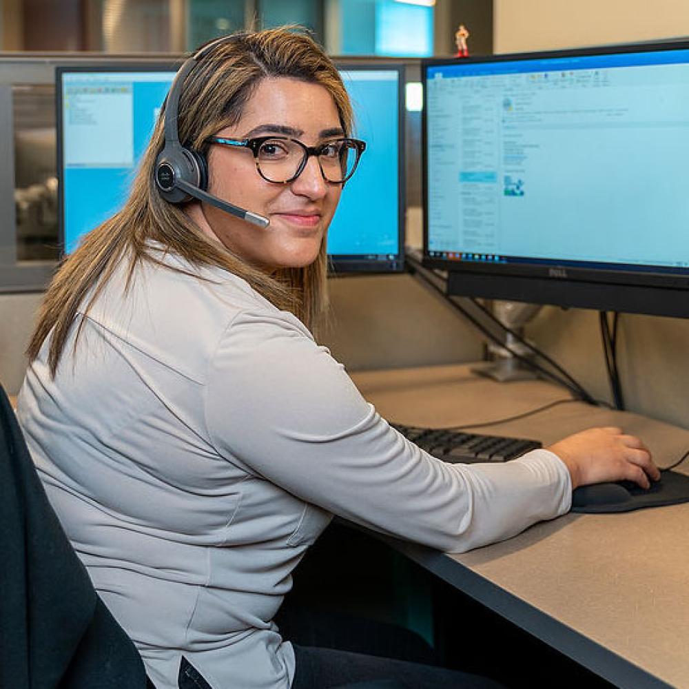 Image of female customer service representative at her desk. 