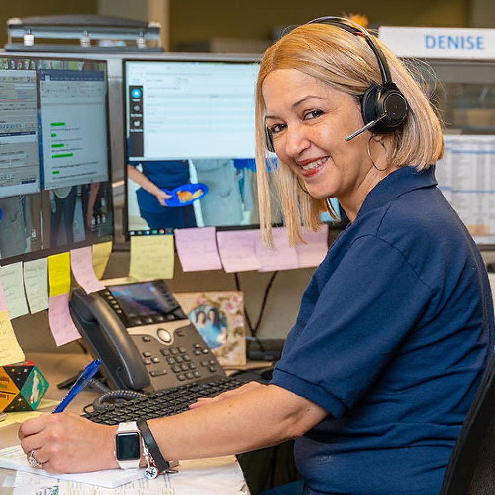 Image of female customer service representative at her desk. 