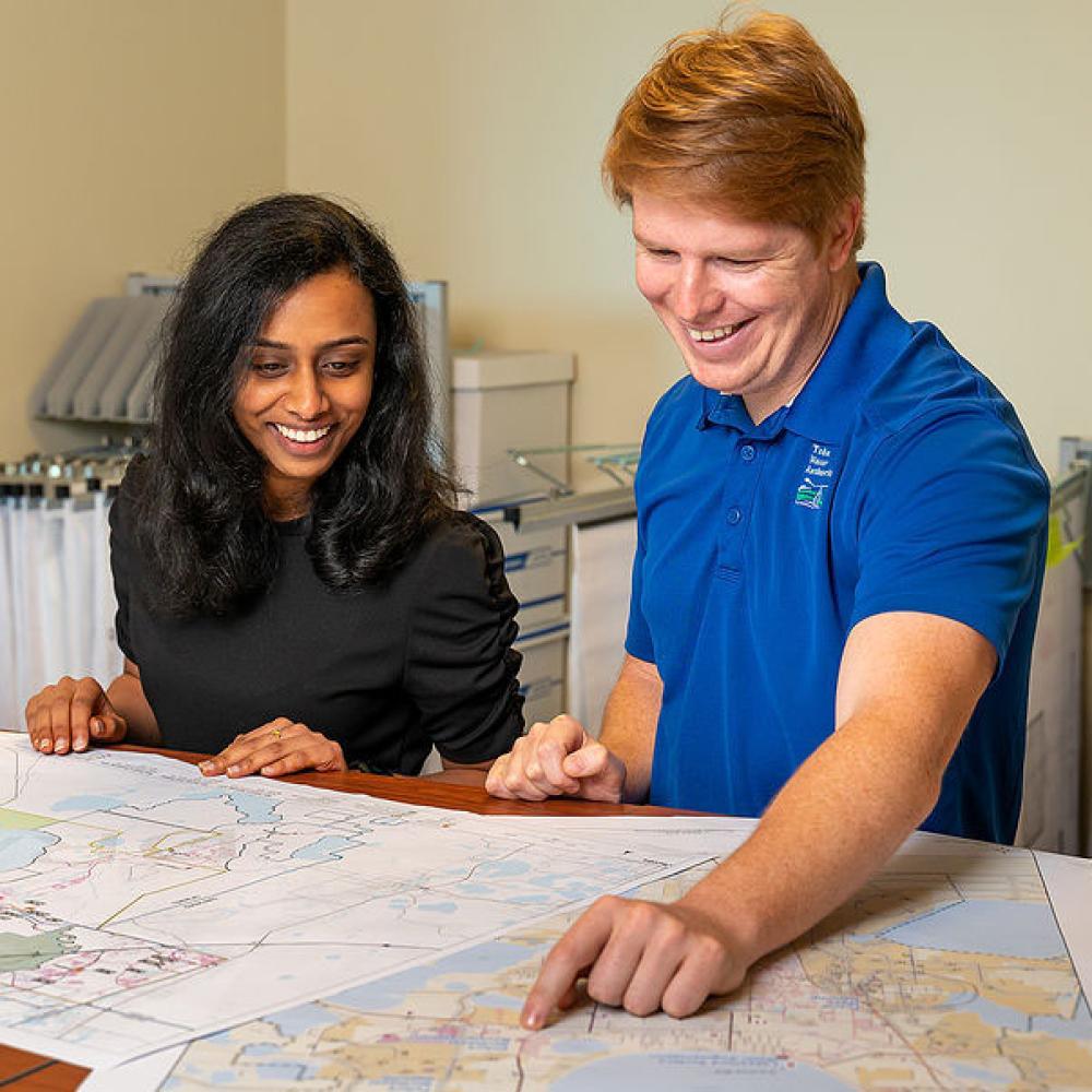 Image of two engineers looking at construction plans. 