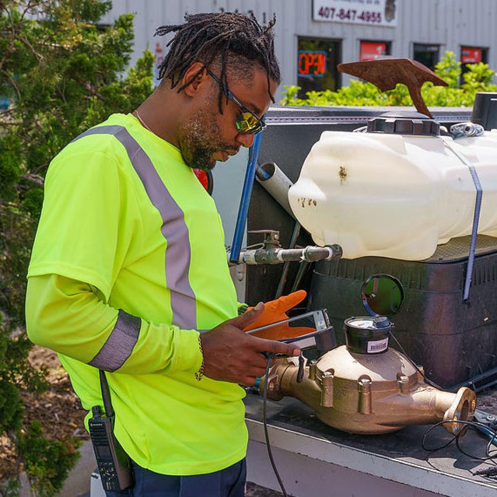 Image of field technician programing water meter.