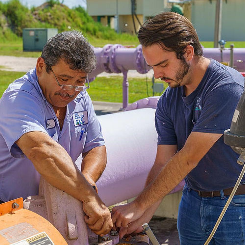 Image of plant operators doing maintenance.