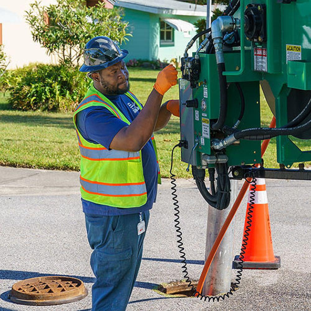 Image of utility worker using machinery.