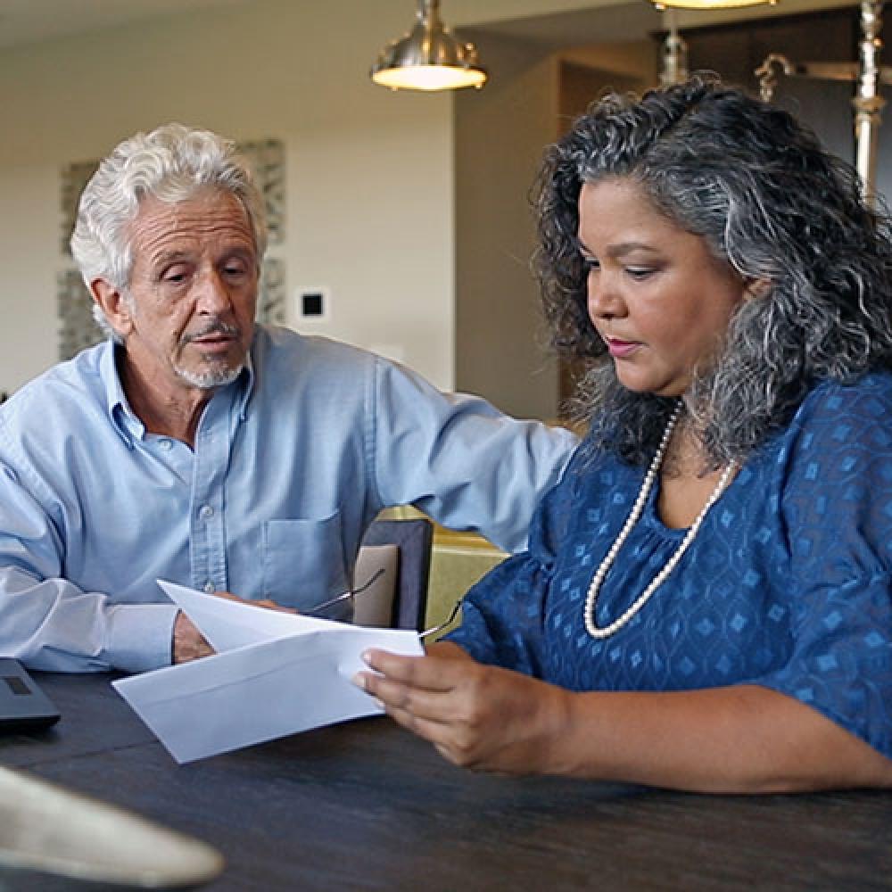 Image of couple looking at bill.