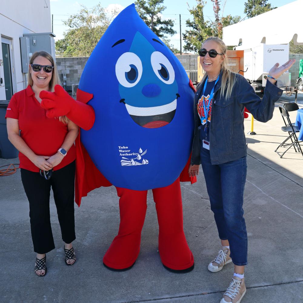 Image of employees with Hydro mascot. 