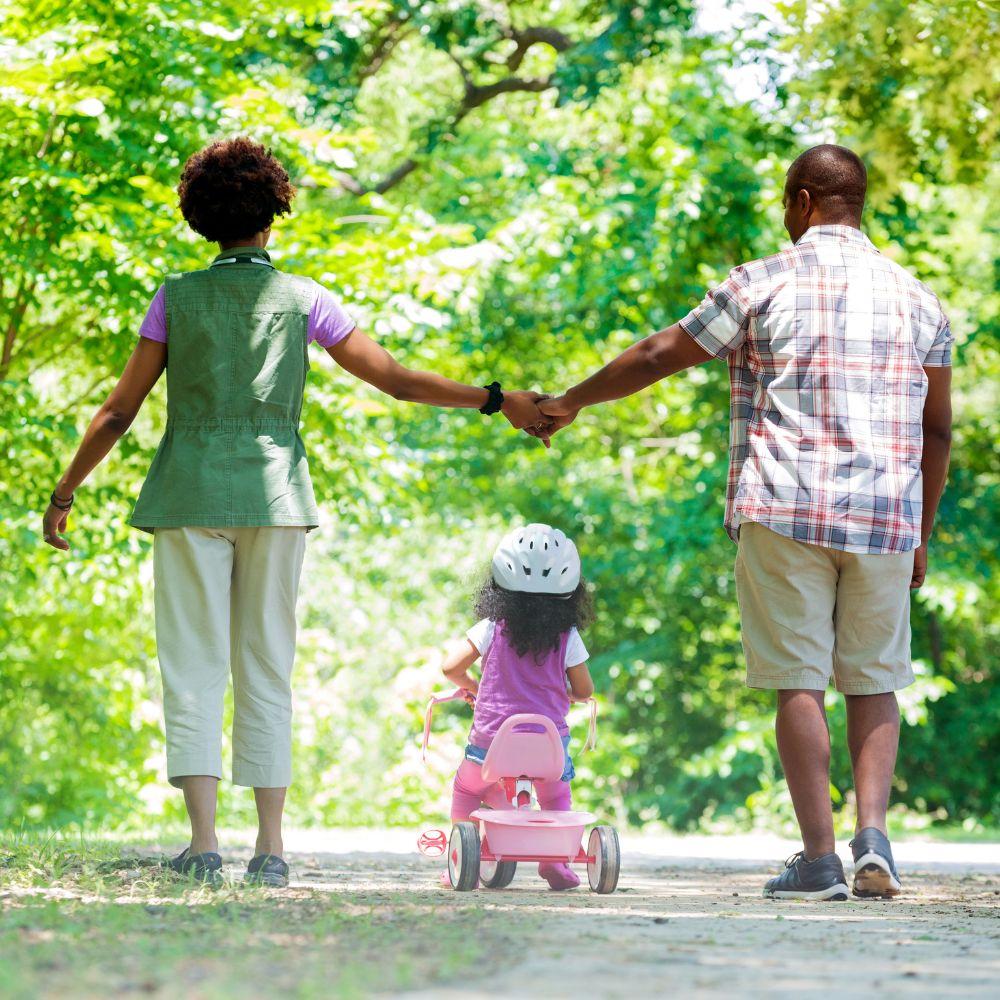 Image of family walking through a park.