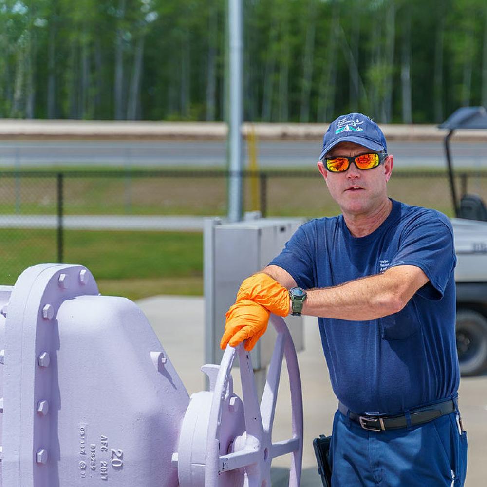 Image of operator turning a valve at a reclaimed water facility.