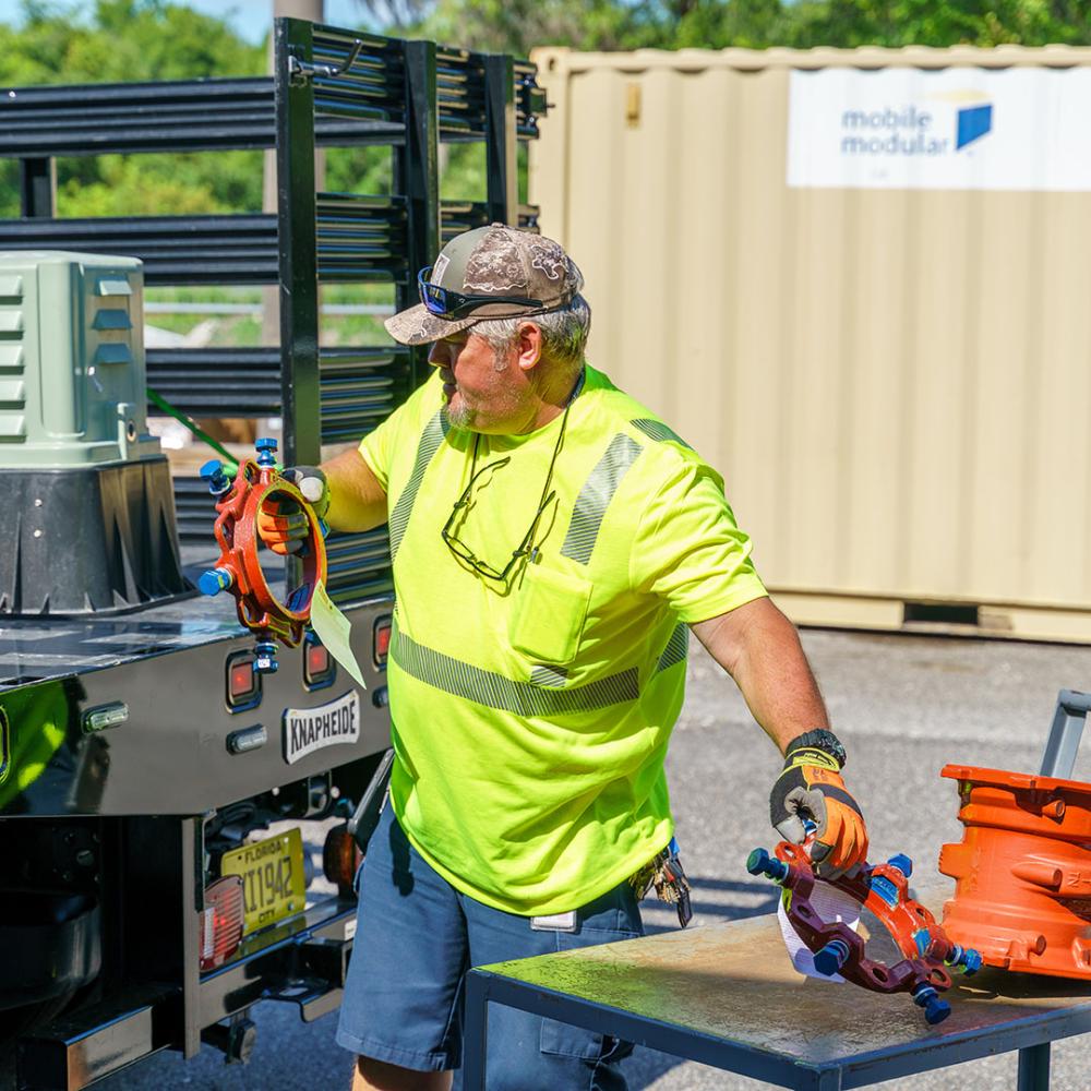 Image of technician loading parts into truck.