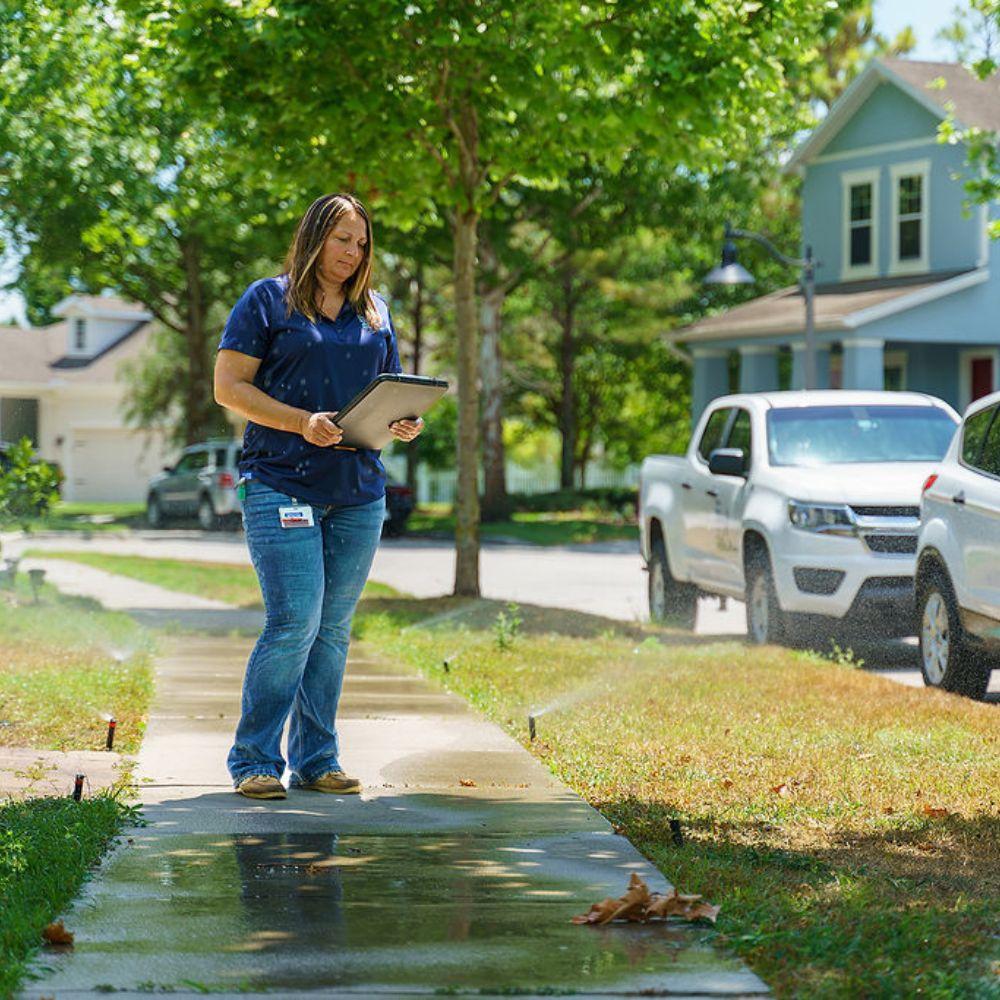 Image of water conservation specialist conducting at irrigation evaluation. 