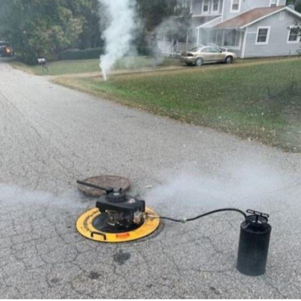 Image of smoke test equipment on manhole.