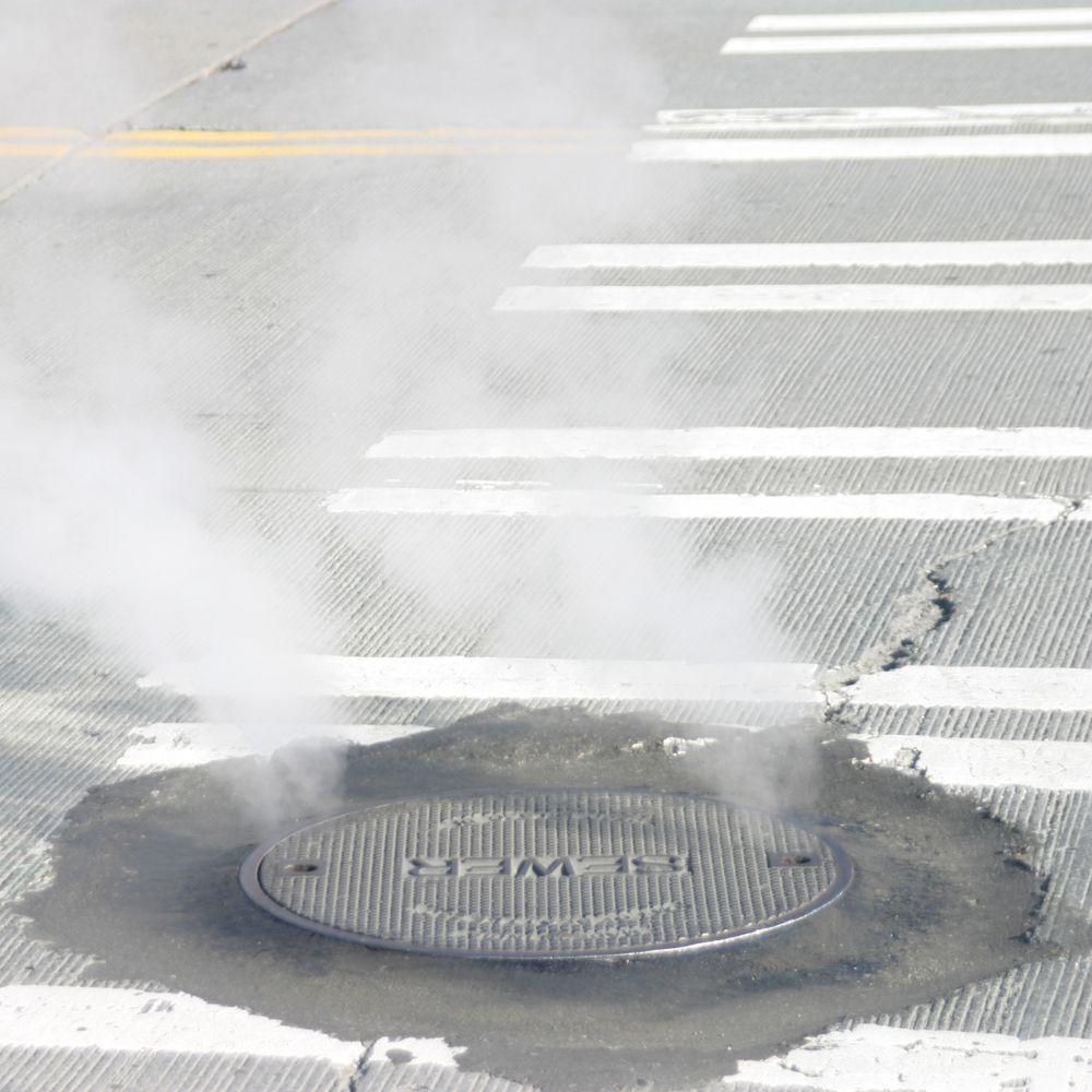 Image of smoke coming from a manhole cover.