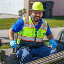 Image of utility worker using machinery.